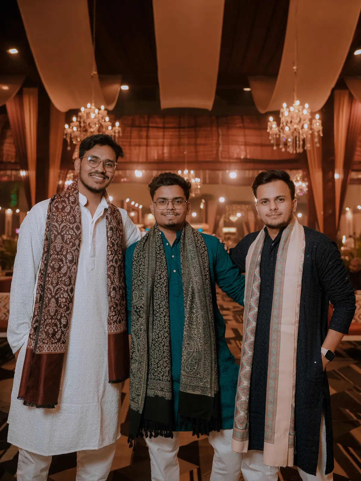 The three of us in kurtas and shawls at a wedding venue